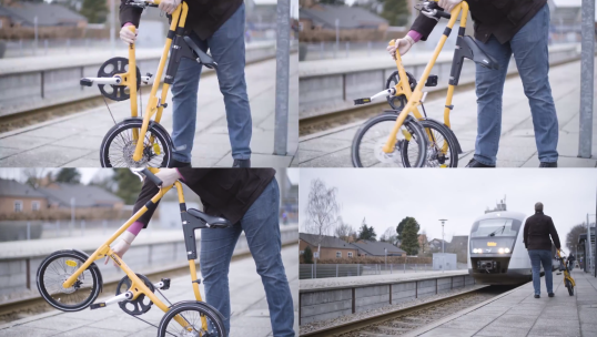 Cyclist folds bike to be brought onto a train