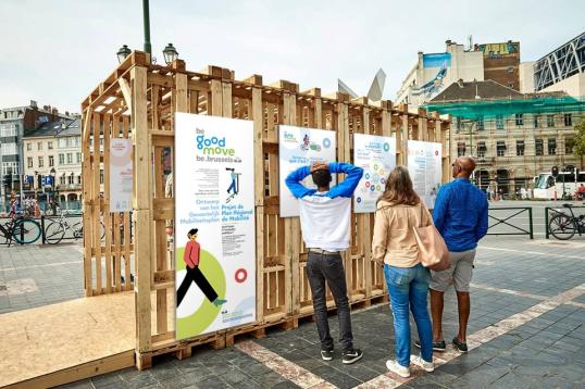 People in Brussels reviewing posters with information about active travel