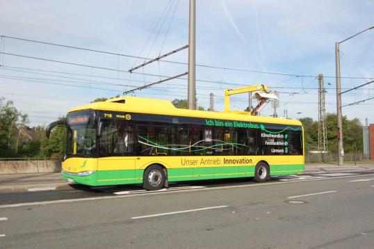 A bus with connectors attached to the overhead tramlines