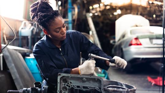 Woman working on car