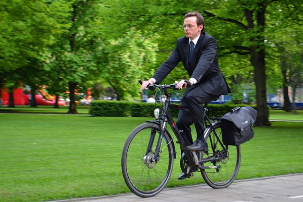 Man on a bike riding through a park